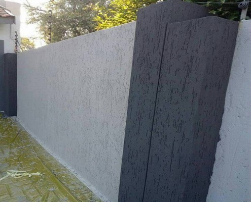 Gray textured exterior wall coating with professional smooth finish